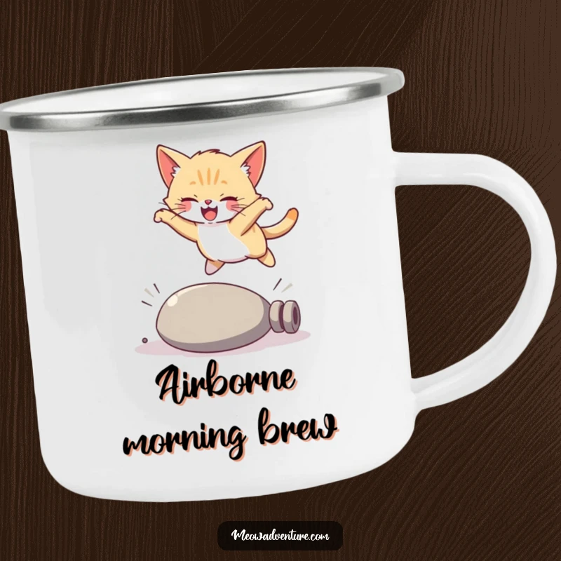 Funny kitten camping mug, a joyful cat performing a graceful leap over a campfire log, ready for adventure.