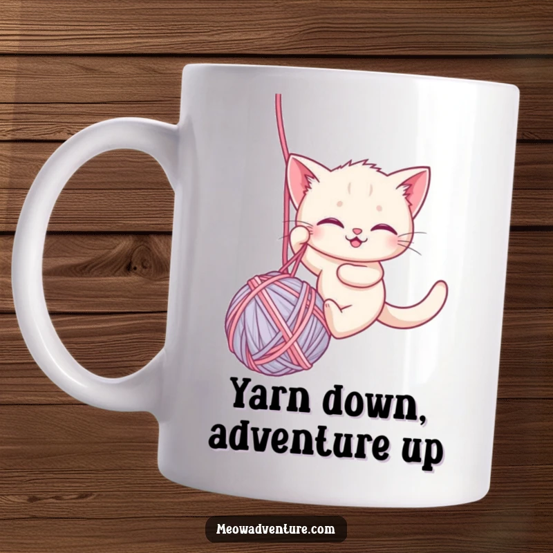 Funny mug showcasing a brave kitten courageously rappelling down a giant ball of yarn, embodying adventurous spirit and humor.