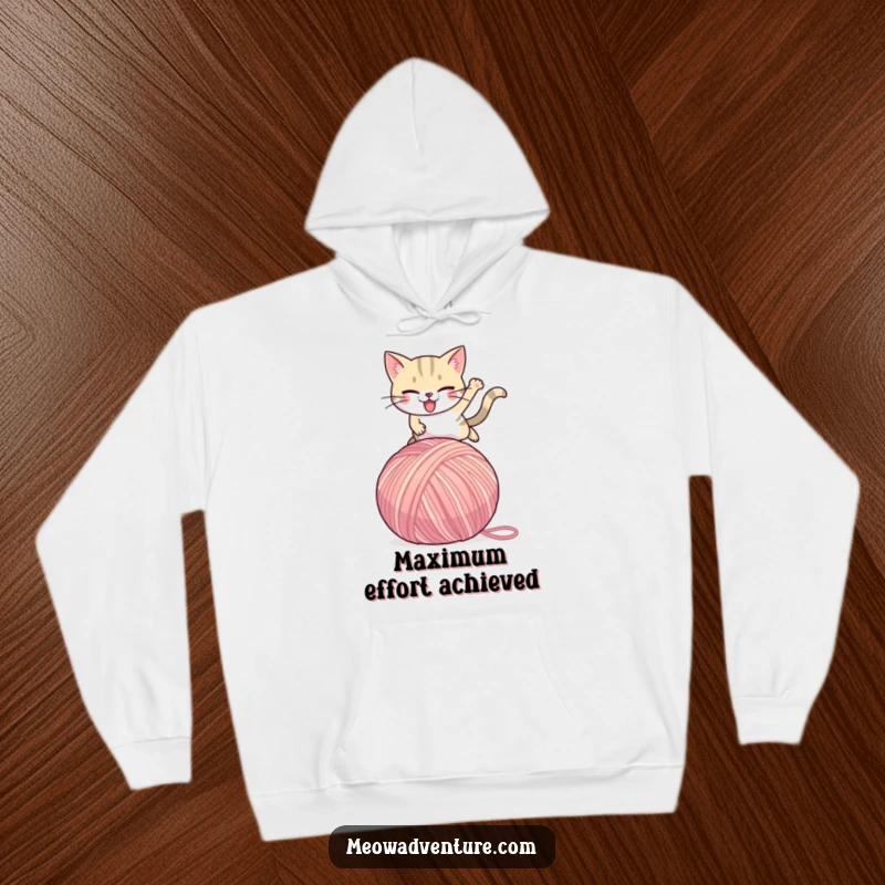 Funny Cat Hoodie: A determined cat in mid-leap over a huge yarn ball, offering cozy comfort and a humorous design for screen readers.
