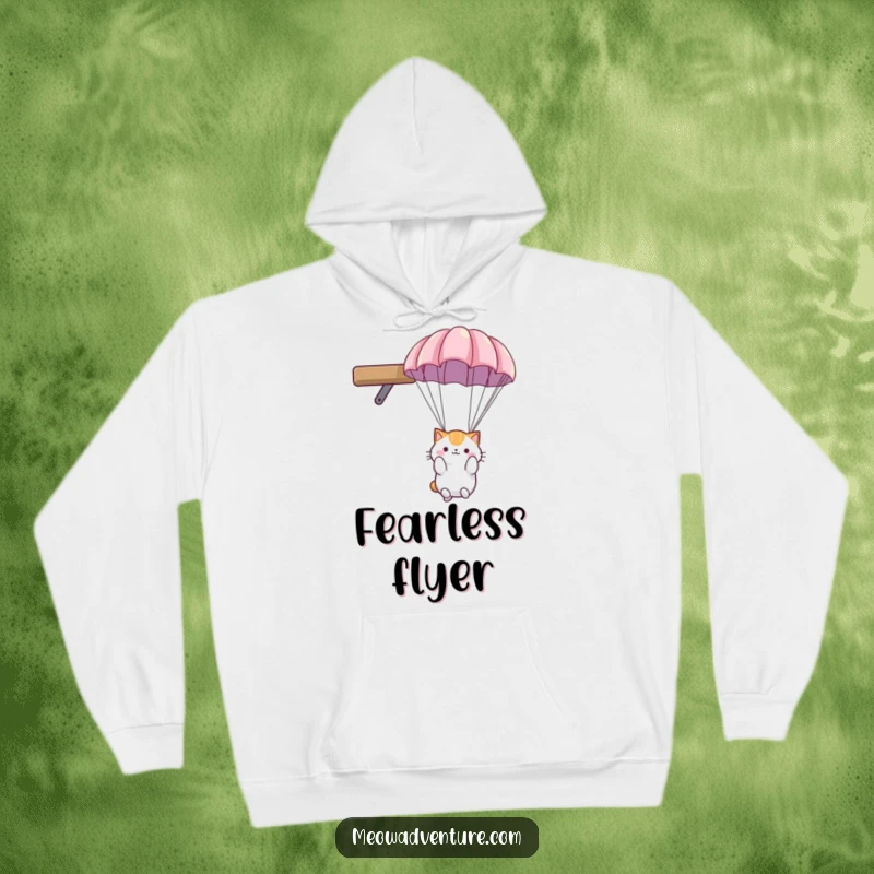 Funny cat hoodie: fluffy cat using a small parachute to descend gently from a high shelf, appearing quite relaxed.