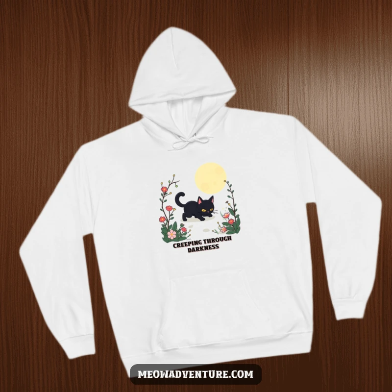 Funny Stealthy Black Cat Garden Hoodie showing a black cat cautiously moving through a moonlit garden scene. A warm, humorous, and mystical top.