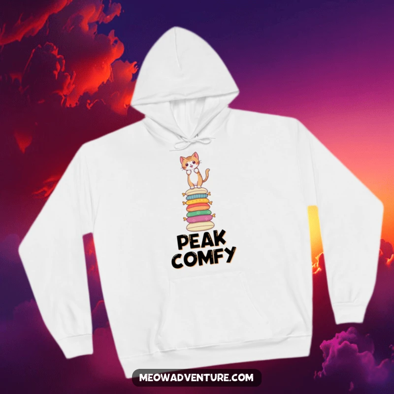 Funny hoodie featuring a brave cat scaling a tall stack of colorful cushions, symbolizing courage.