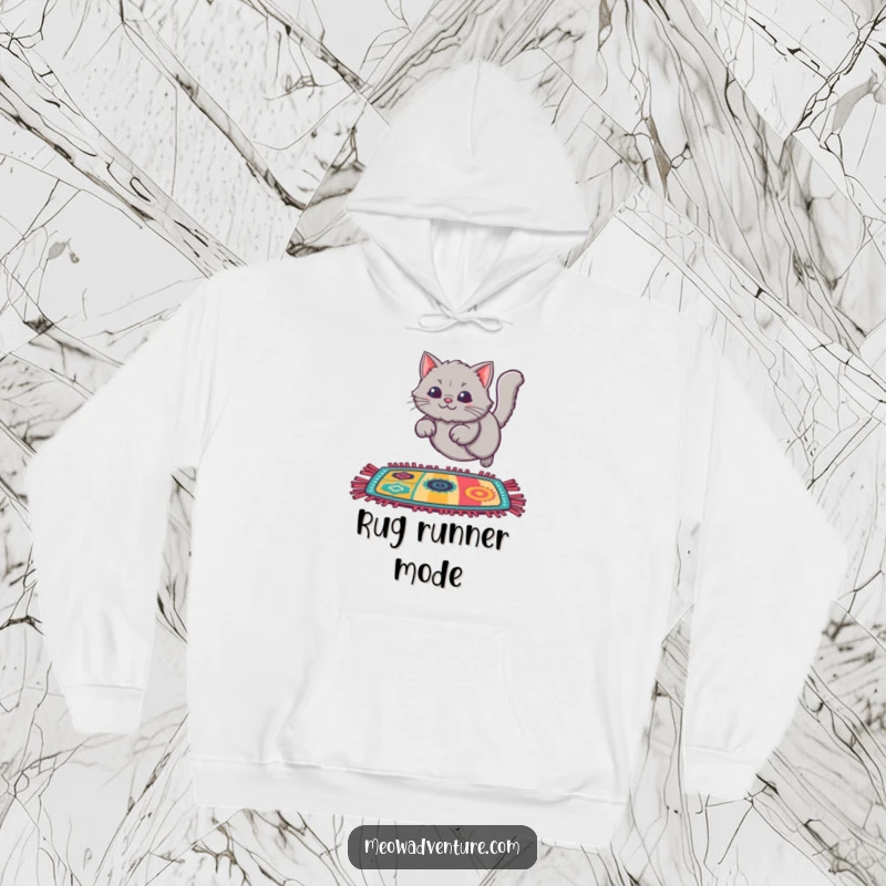 Funny Cat Rug Leap Hoodie featuring a fluffy grey cat leaping onto a colorful rug, offering cozy warmth and playful charm.
