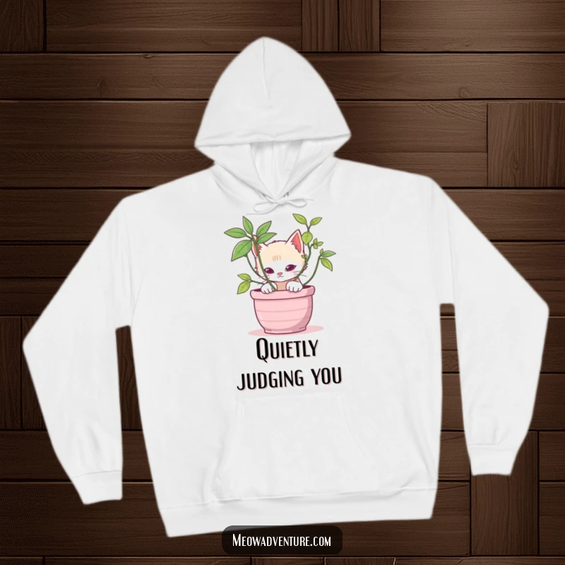 Stealthy kitten hoodie featuring a cat peeking from behind a potted plant, offering cozy comfort and playful charm.