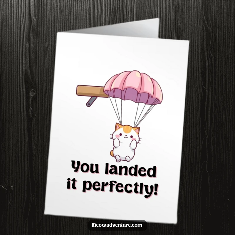 Funny Free Printable Congrats Card: Cat in parachute landing gently from a shelf, celebrating achievement.