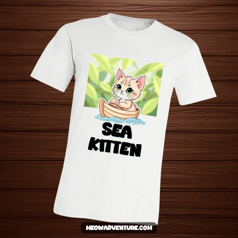 Funny t-shirt depicting a determined kitten with wide eyes sailing on a tiny leafy boat, celebrating feline bravery.